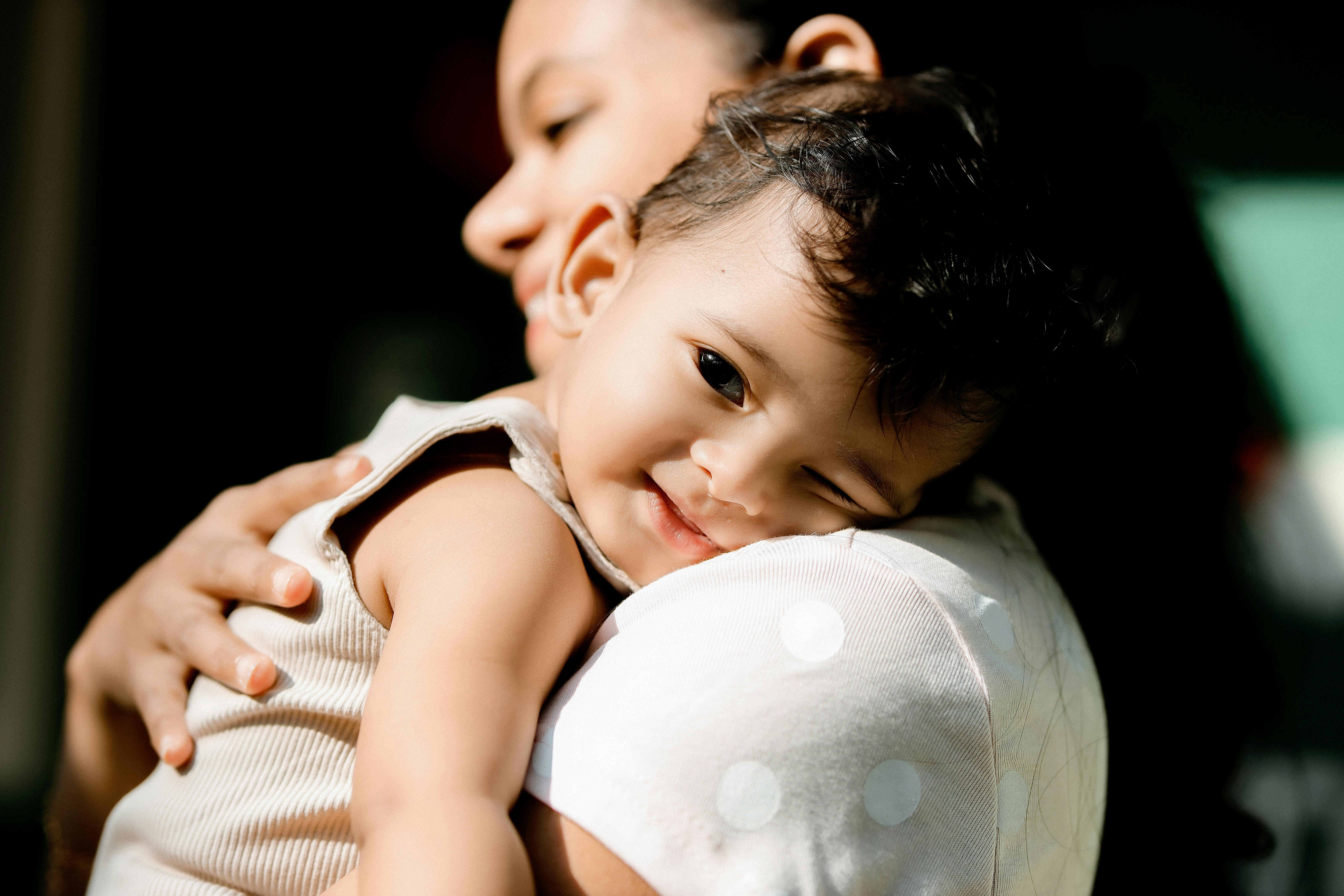 Parent holding a smiling child