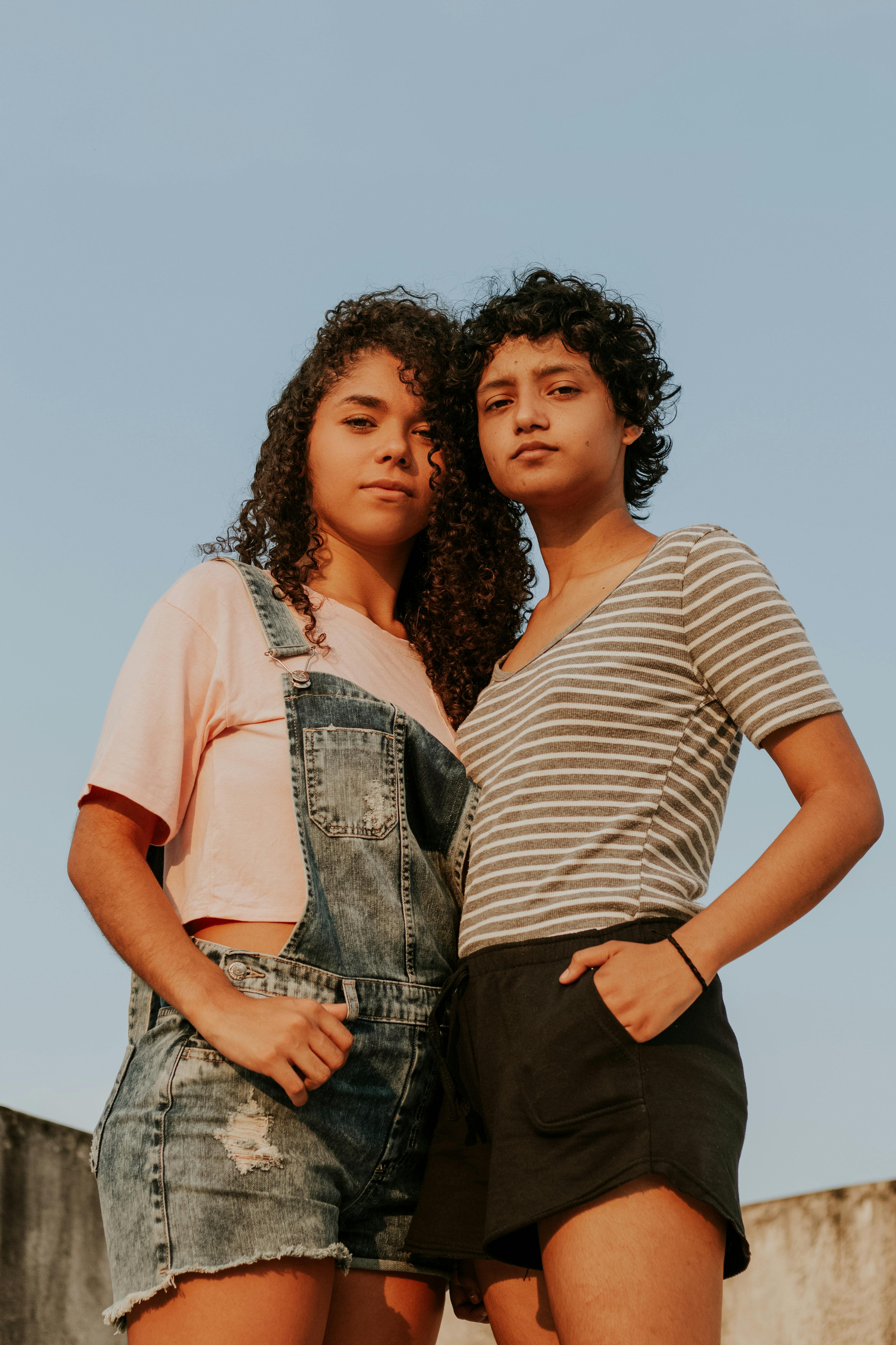 Two young women standing confidently
